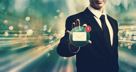 Email with businessman on blue tech backgroundの写真素材