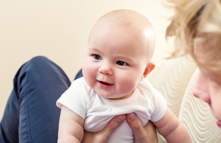 Happy little baby girl playing with her father