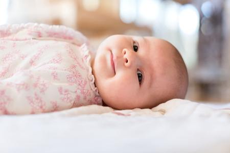 Newborn baby girl lying on her blanketの写真素材