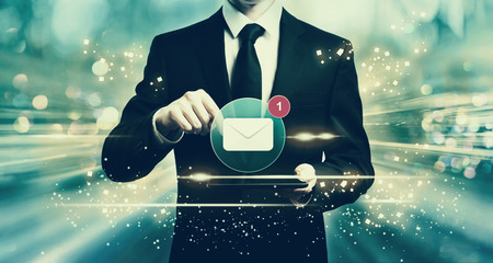 Email with man holding a tablet computerの写真素材