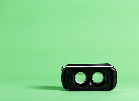 Virtual reality headset device on a green backgroundの写真素材