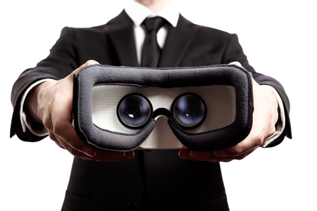 Businessman with a virtual reality headset isolated on a white backgroundの写真素材