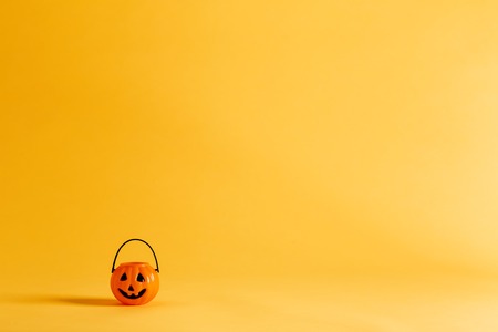 Halloween pumpkin decoration on a yellow-orange backgroundの写真素材