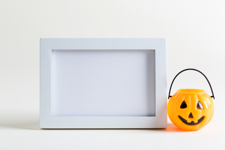 Empty photo frame with Halloween pumpkin decorationの写真素材