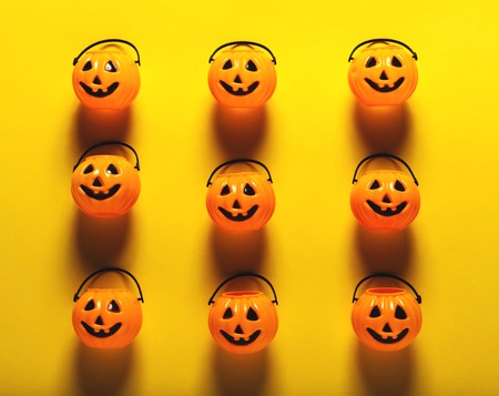 Halloween pumpkin decorations on a yellow-orange backgroundの写真素材