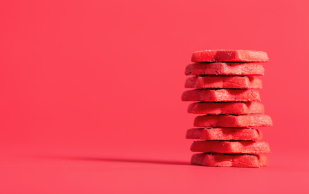 Stack of red cookies on a red background