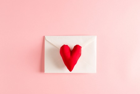 Love and Valentines Day theme with heart cushions and envelopeの写真素材