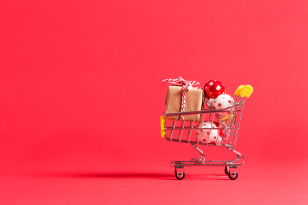 Holiday shopping theme with shopping cart filled with giftboxesの写真素材