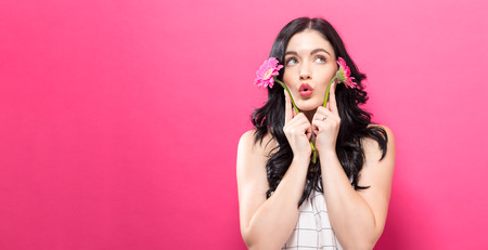 Young woman with garbela on a pink backgroundの写真素材