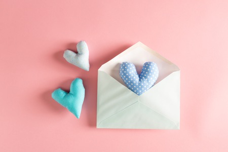 Heart shaped cushions coming out of a gift envelope - love and Valentines Day themeの写真素材