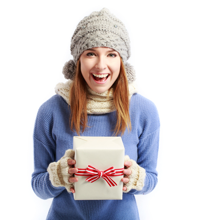 Happy young woman holding a Christmas presentの写真素材