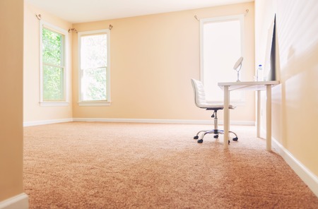 Large interior room with sunlight and carpetの写真素材