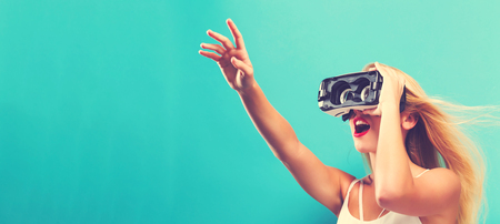 Happy young woman using a virtual reality headset