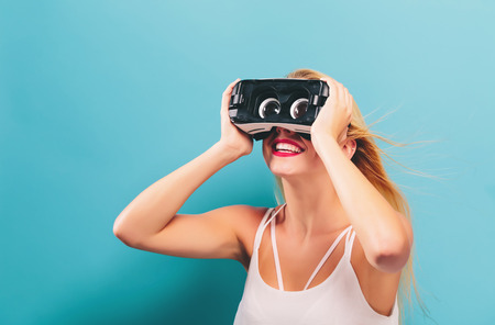 Happy young woman using a virtual reality headset