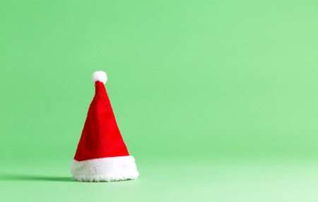 Santa hat on a bright green background