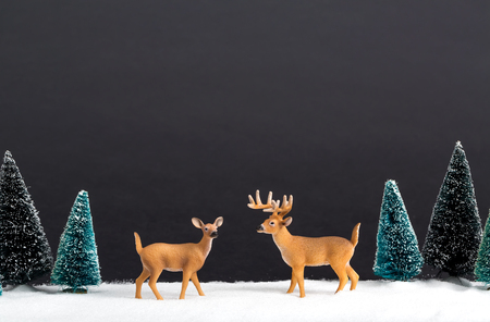 Christmas holiday theme with reindeer and Christmas treesの写真素材