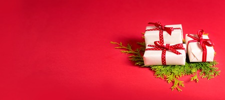 Collection of Christmas present boxes on a red backgroundの写真素材