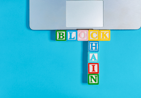 Blockchain concept with toy blocks on a laptopの写真素材