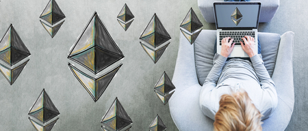 Ethereum with man using a laptop in a modern gray chair