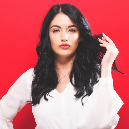 Beautiful young woman on a solid backgroundの写真素材