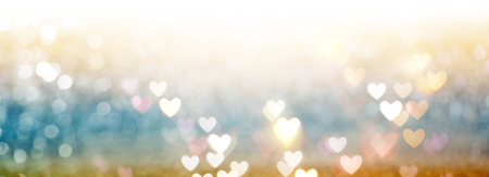 Beautiful shiny hearts and abstract lights backgroundの写真素材