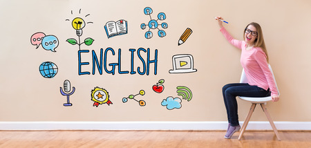 English with young woman holding a pen in a chairの写真素材