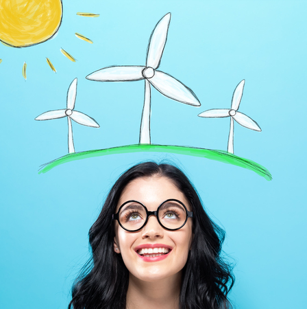 Windmills with happy young woman on a blue backgroundの写真素材