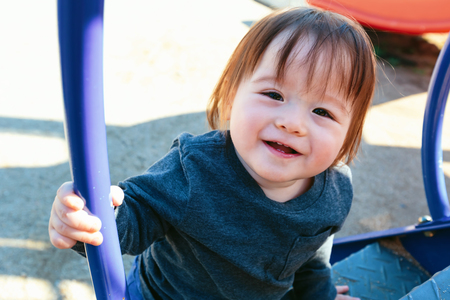 Mutliethnic toddler boy playing on a playground in Japanの写真素材