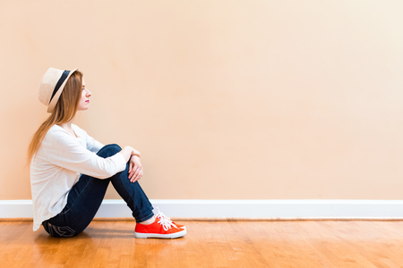 Young woman thinking about something in a big roomの写真素材