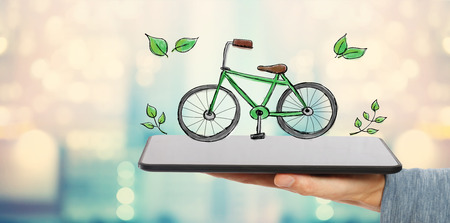 Eco Bicycle with man holding a tablet computerの写真素材