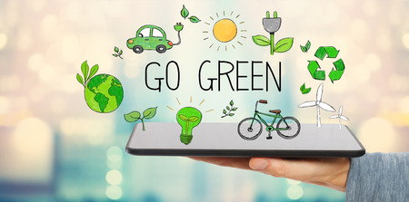 Go Green with man holding a tablet computerの写真素材