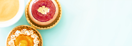 Handcrafted gourmet fruit tarts and pastries with coffeeの写真素材