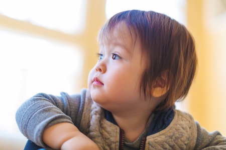 Toddler boy in his house looking into the distanceの写真素材