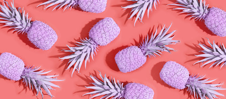 Painted pineapples on a vivid pink backgroundの写真素材