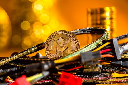 Monero cryptocurrency coin with compute wires on a golden backgroundの写真素材