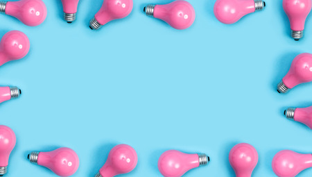 Pink painted lightbulbs on a blue backgroundの写真素材