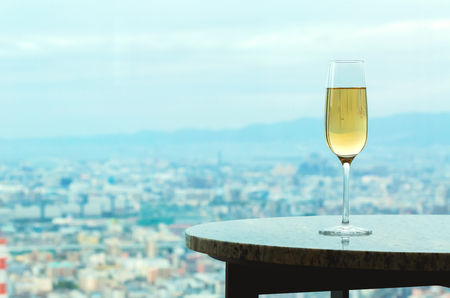 White wine on a table high above the cityの写真素材