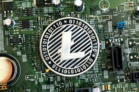 Litecoin cryptocurrency coin on a computer chipの写真素材