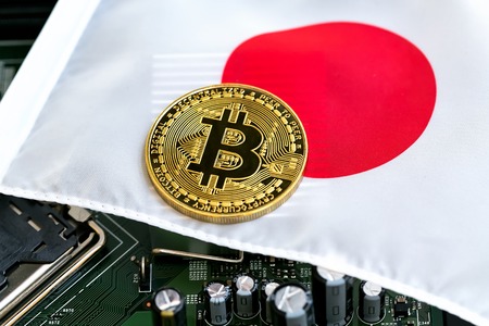 Bitcoin cryptocurrency coin on a Japanese flagの写真素材