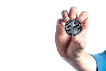 Litecoin cryptocurrency coin held by a man on a white backgroundの写真素材