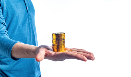 Stack of Bitcoin cryptocurrency coins held by a man on a white backgroundの写真素材
