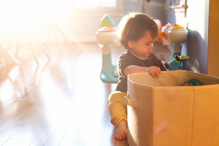 Happy toddler boy playing with toys in his houseの写真素材