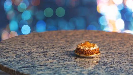 Pastry on a table high above the city lights at nightの写真素材