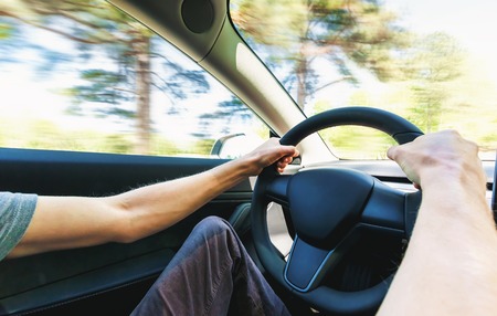 Person driving a new electric vehicle from inside