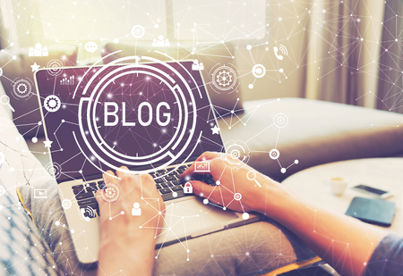 Blog with person using a laptop computerの写真素材