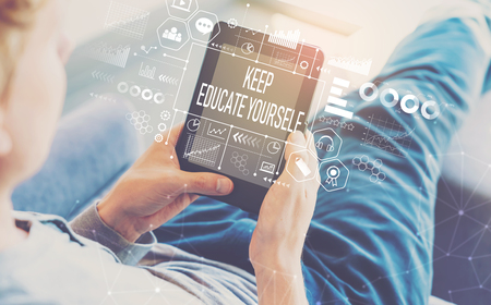 Keep educate yourself with man using a tablet in a chairの写真素材