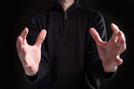 Man holding his hands out and showing somethingの写真素材