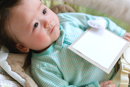 Newborn baby boy sitting in his rocking swingの写真素材