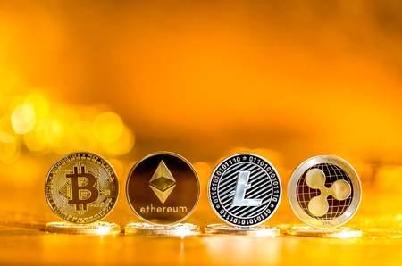 Cryptocurreny coins on a shining gold backgroundの写真素材