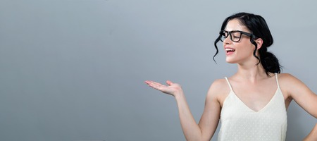 Young woman with a displaying hand gesture
